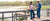 Man and woman on dock in the low country in classic, southern apparel.