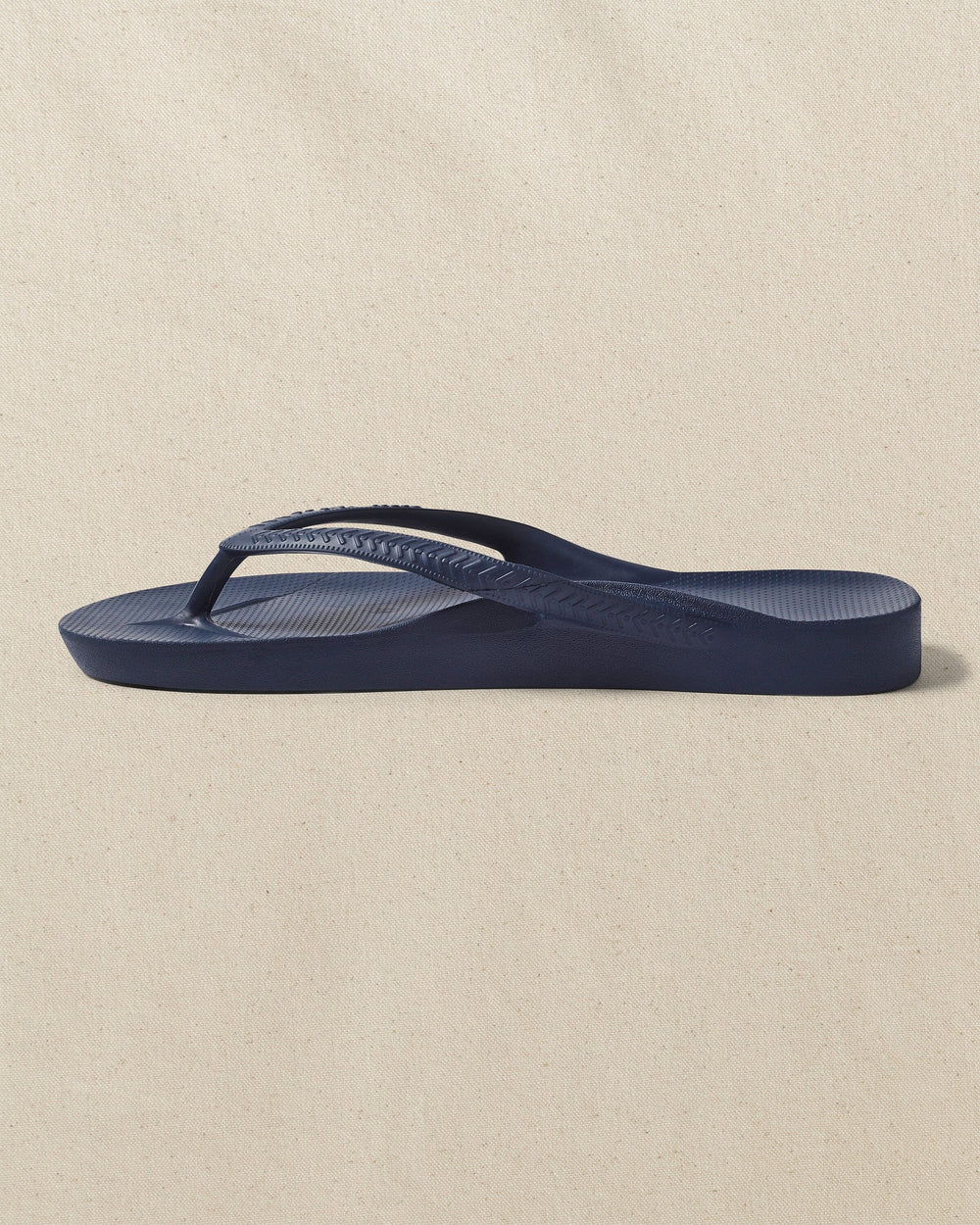 The left side view of the Southern Tide Archie's Navy Arch Support Flip Flop by Southern Tide - Navy