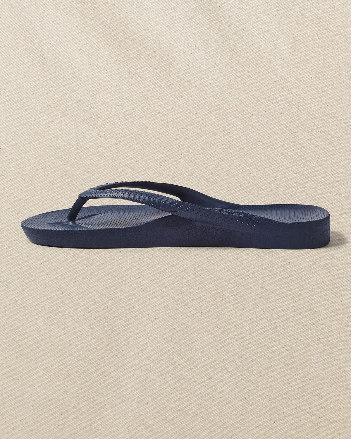 The left side view of the Southern Tide Archie's Navy Arch Support Flip Flop by Southern Tide - Navy
