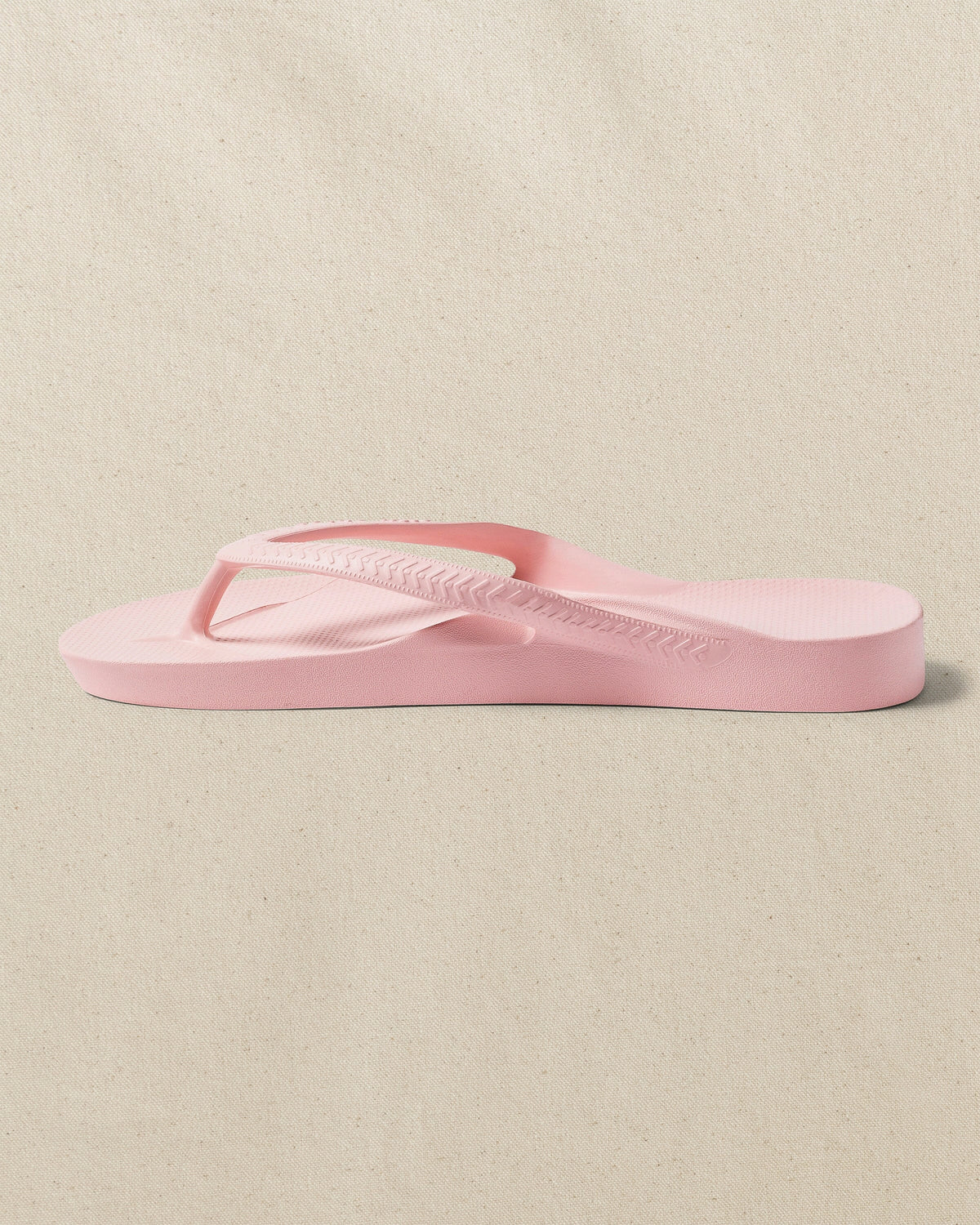 The left side view of the Southern Tide Archie's Soft Pink Arch Support Flip Flop by Southern Tide - Soft Pink