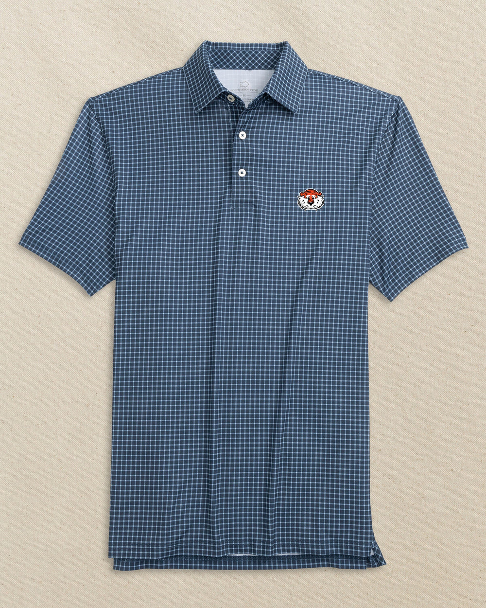 The front view of the Southern Tide Auburn Tiger Head Driver Dunes Edge Plaid Polo by Southern Tide - Navy