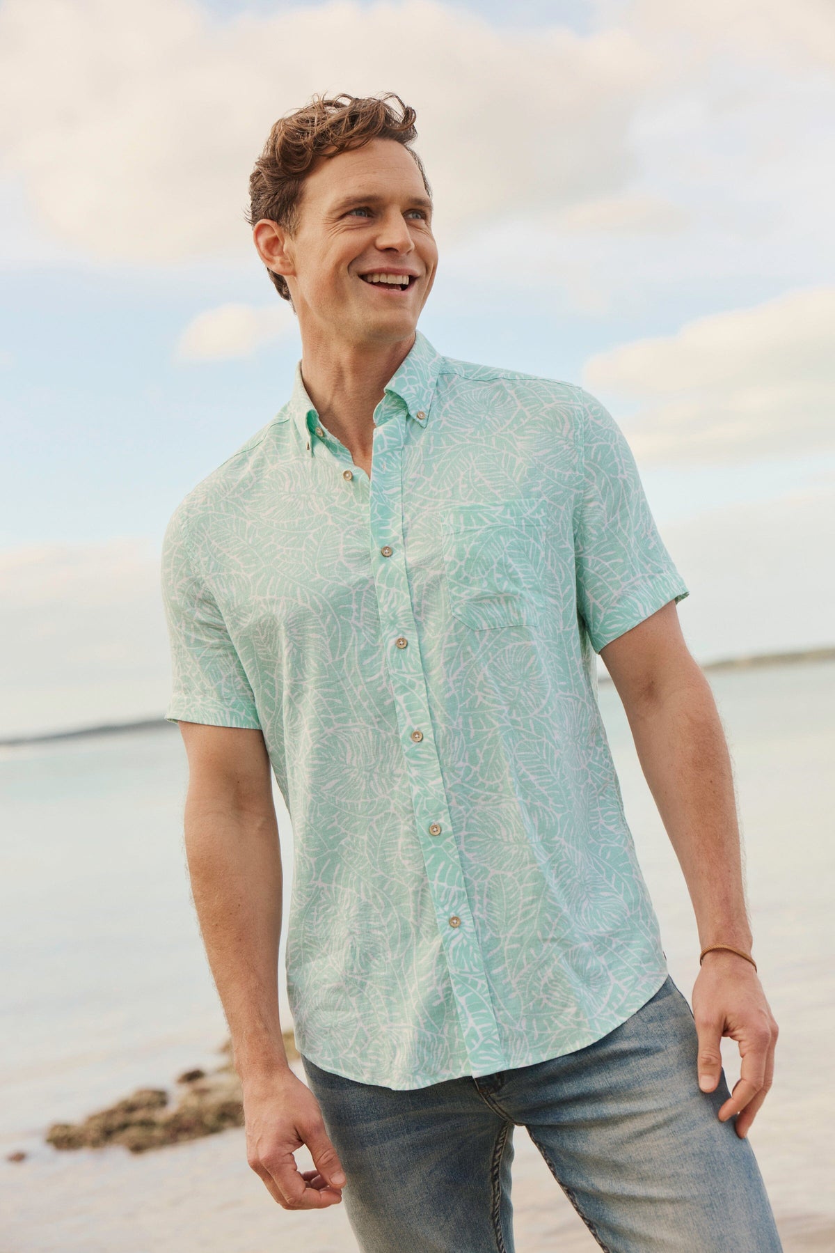 The lifestyle view of the Southern Tide Beach Palms Linen Rayon Short Sleeve Sport Shirt by Southern Tide - Garden Grove