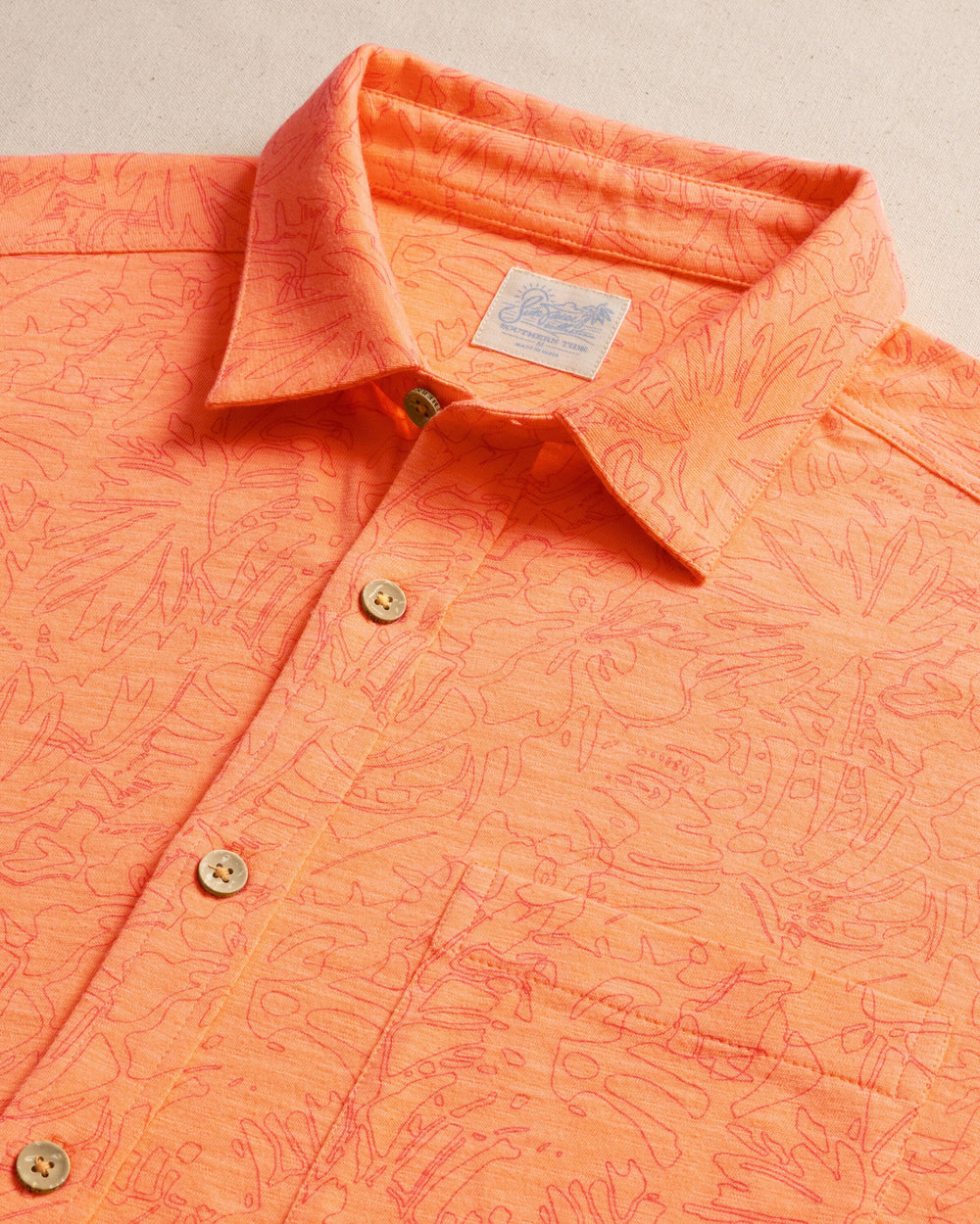 The detail view of the Southern Tide Beachcast Floral Fusion Knit Short Sleeve Sport Shirt by Southern Tide - Cantaloupe