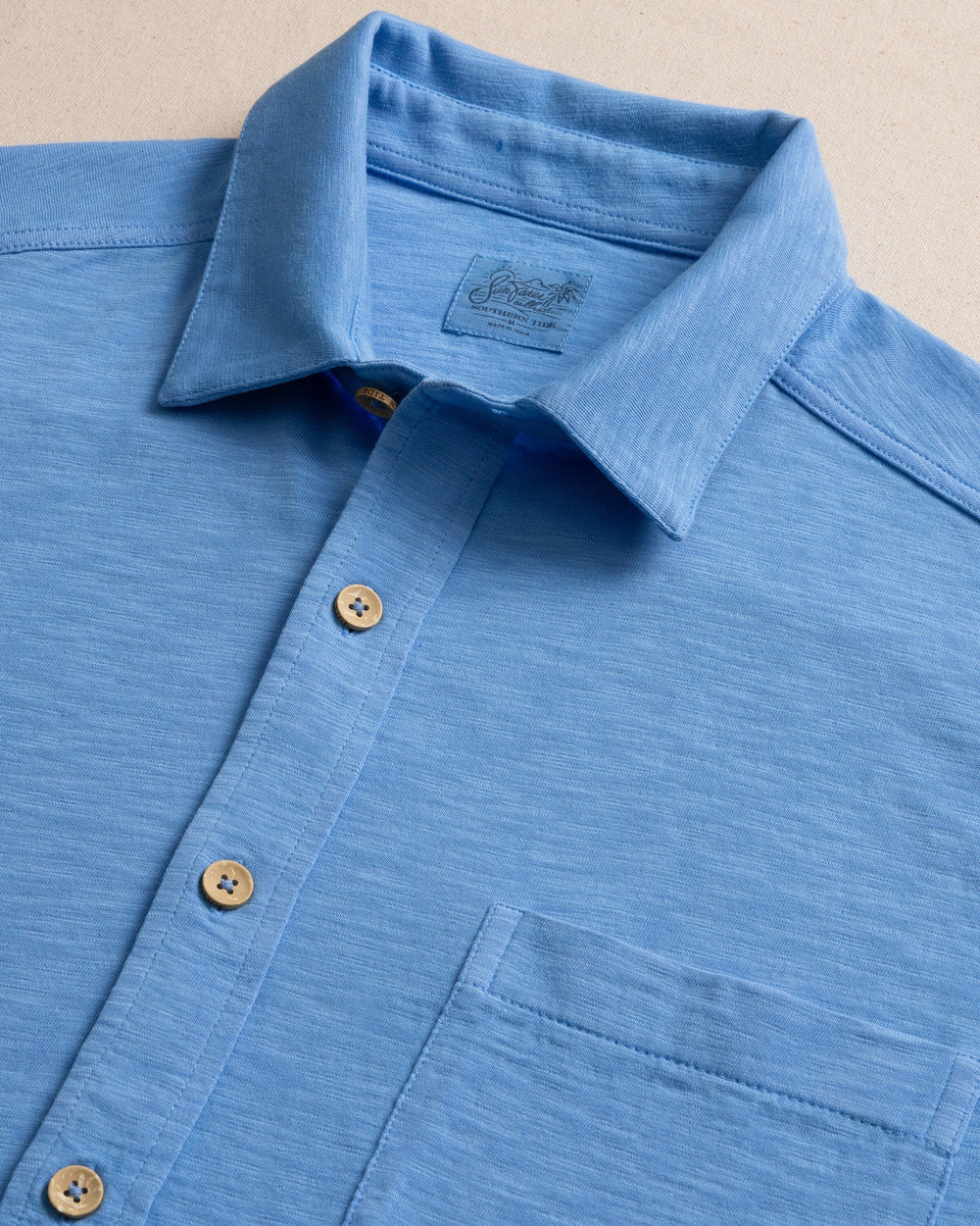 The detail view of the Southern Tide Beachcast Solid Knit Short Sleeve Sport Shirt by Southern Tide - Boat Blue