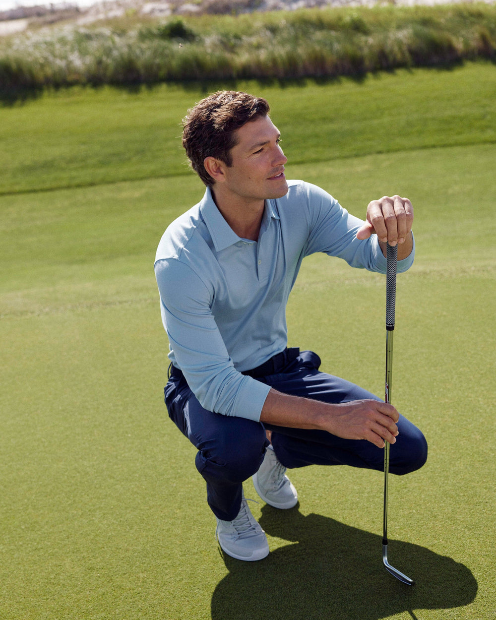 The lifestyle view of the Southern Tide Belfair Performance Long Sleeve Polo by Southern Tide - Triumph Blue