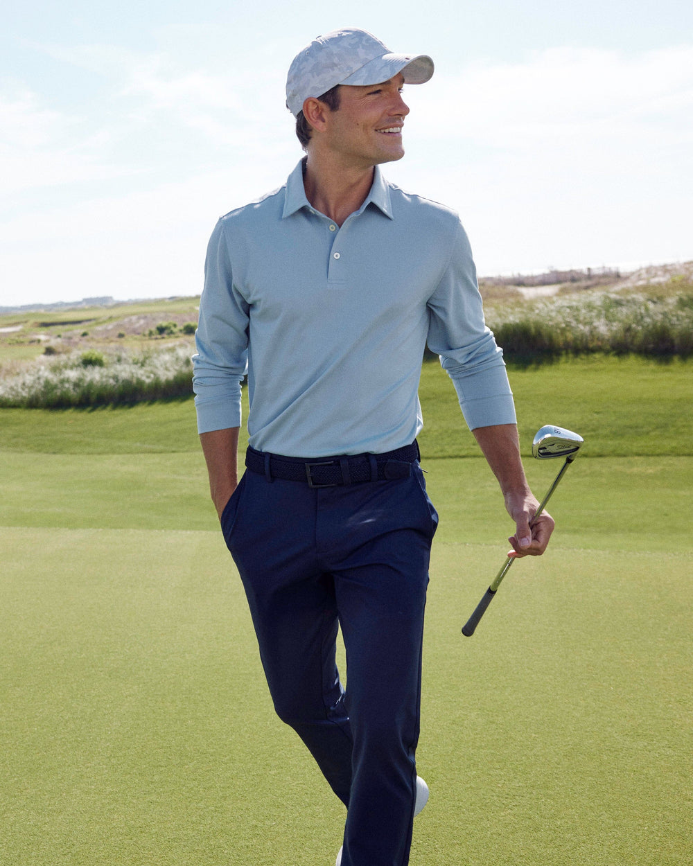The lifestyle view of the Southern Tide Belfair Performance Long Sleeve Polo by Southern Tide - Triumph Blue