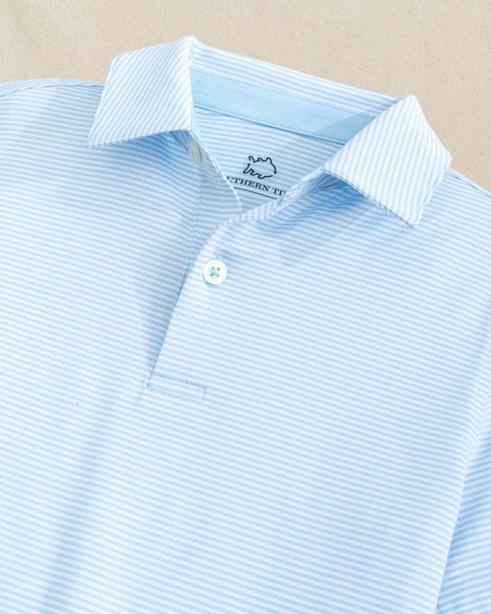 The detail view of the Southern Tide Boys Driver Meadowbrook Stripe Performance Polo by Southern Tide - Clearwater Blue