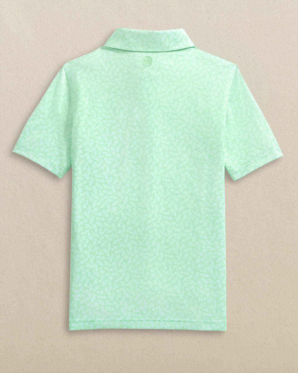 The back view of the Southern Tide Boys Driver Pineapple Parade Printed Performance Polo by Southern Tide - Green Ash