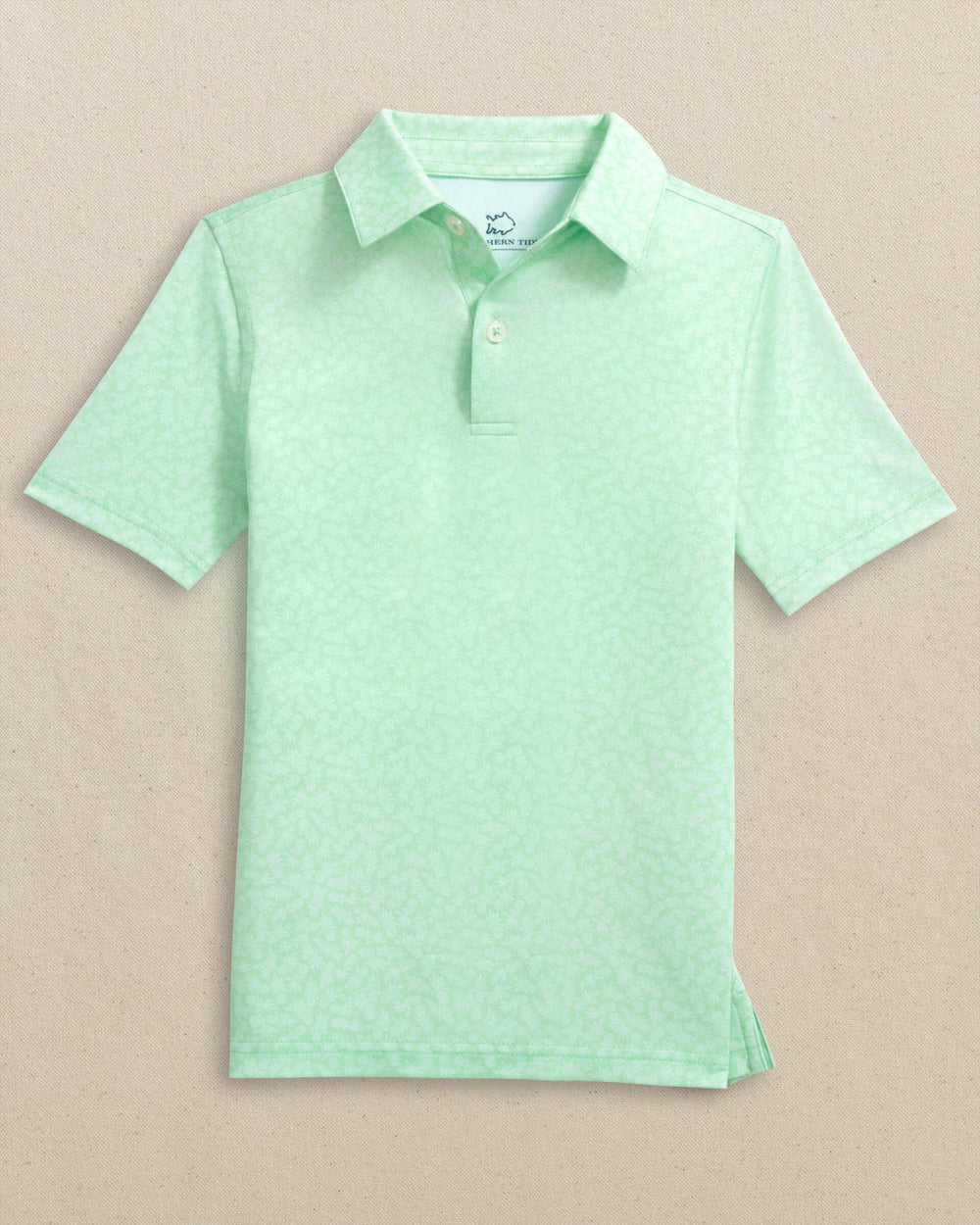 The front view of the Southern Tide Boys Driver Pineapple Parade Printed Performance Polo by Southern Tide - Green Ash