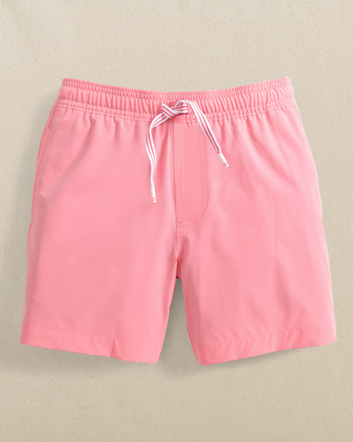 The front view of the Southern Tide Boys Solid Maritime Swim Trunk by Southern Tide - Sea Pink