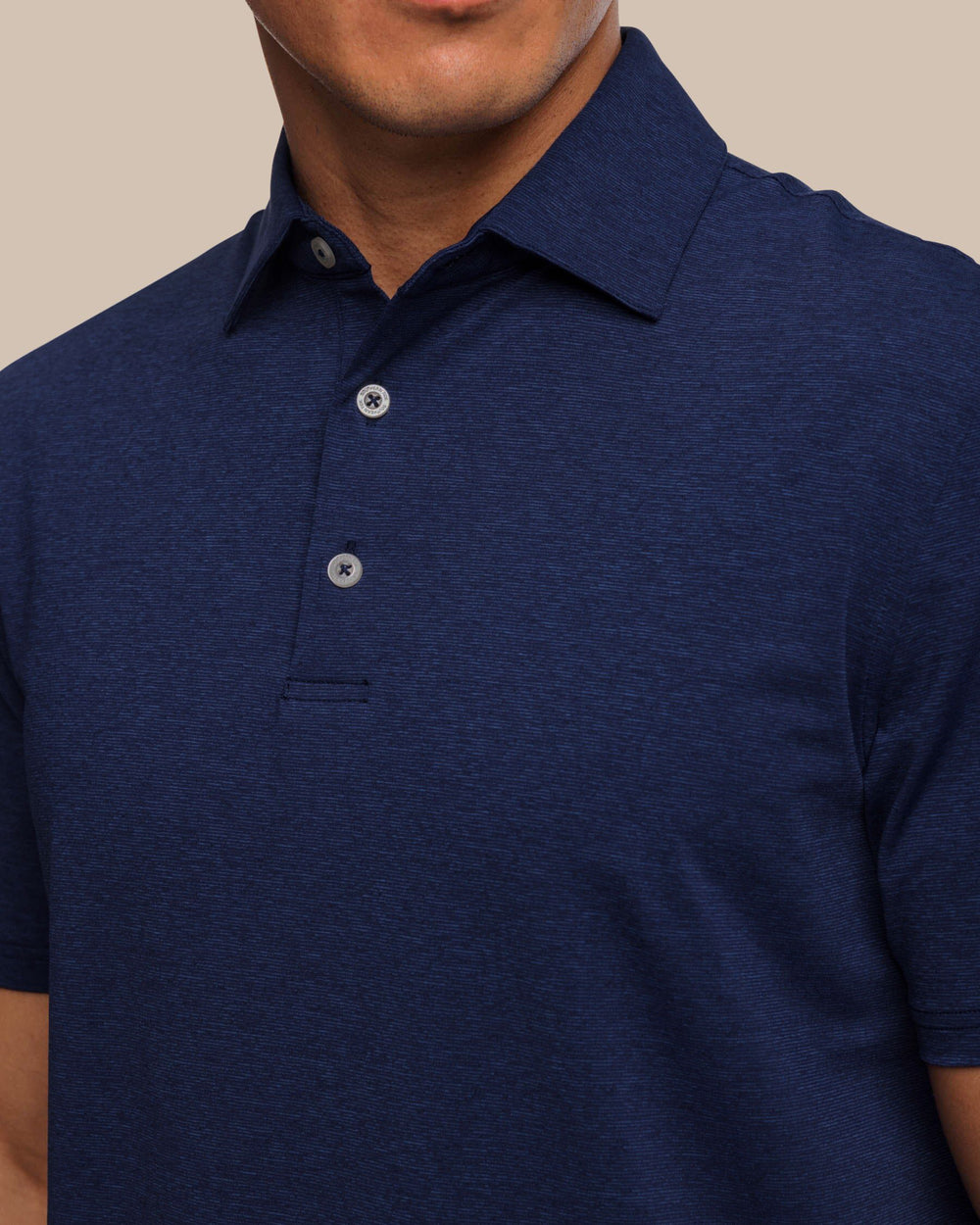 The detail view of the brrr°®-eeze Heather Performance Polo Shirt by Southern Tide - Heather Nautical Navy