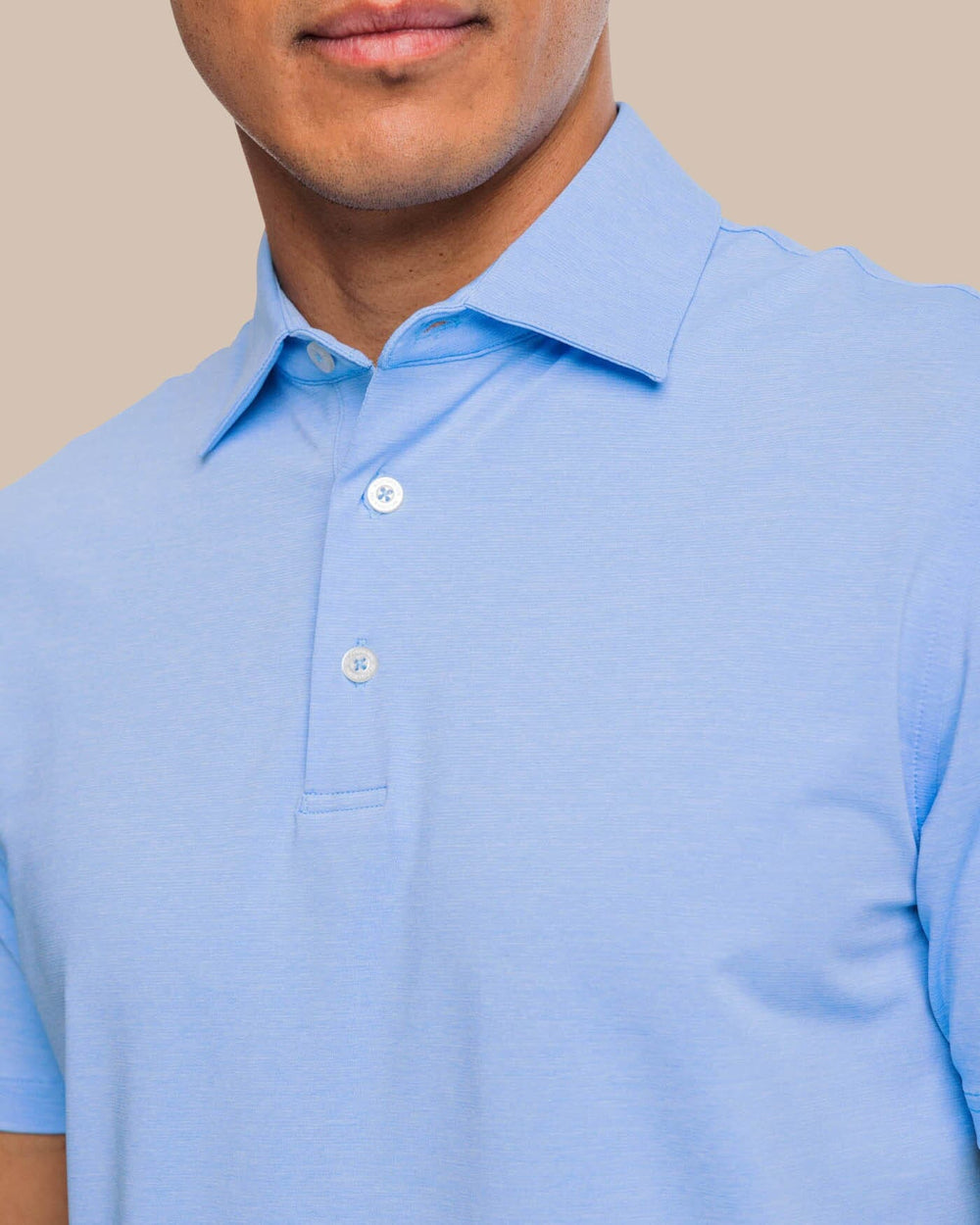 The detail view of the brrr°®-eeze Heather Performance Polo Shirt by Southern Tide - Heather Ocean Channel