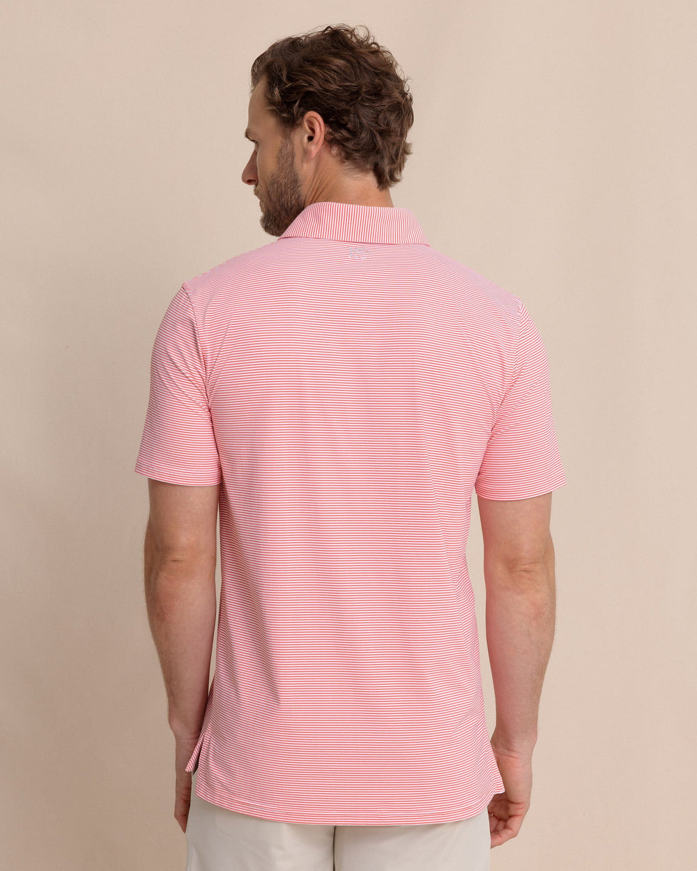 The back view of the Southern Tide brrr°®-eeze Meadowbrook Stripe Polo by Southern Tide - Sunkist Coral