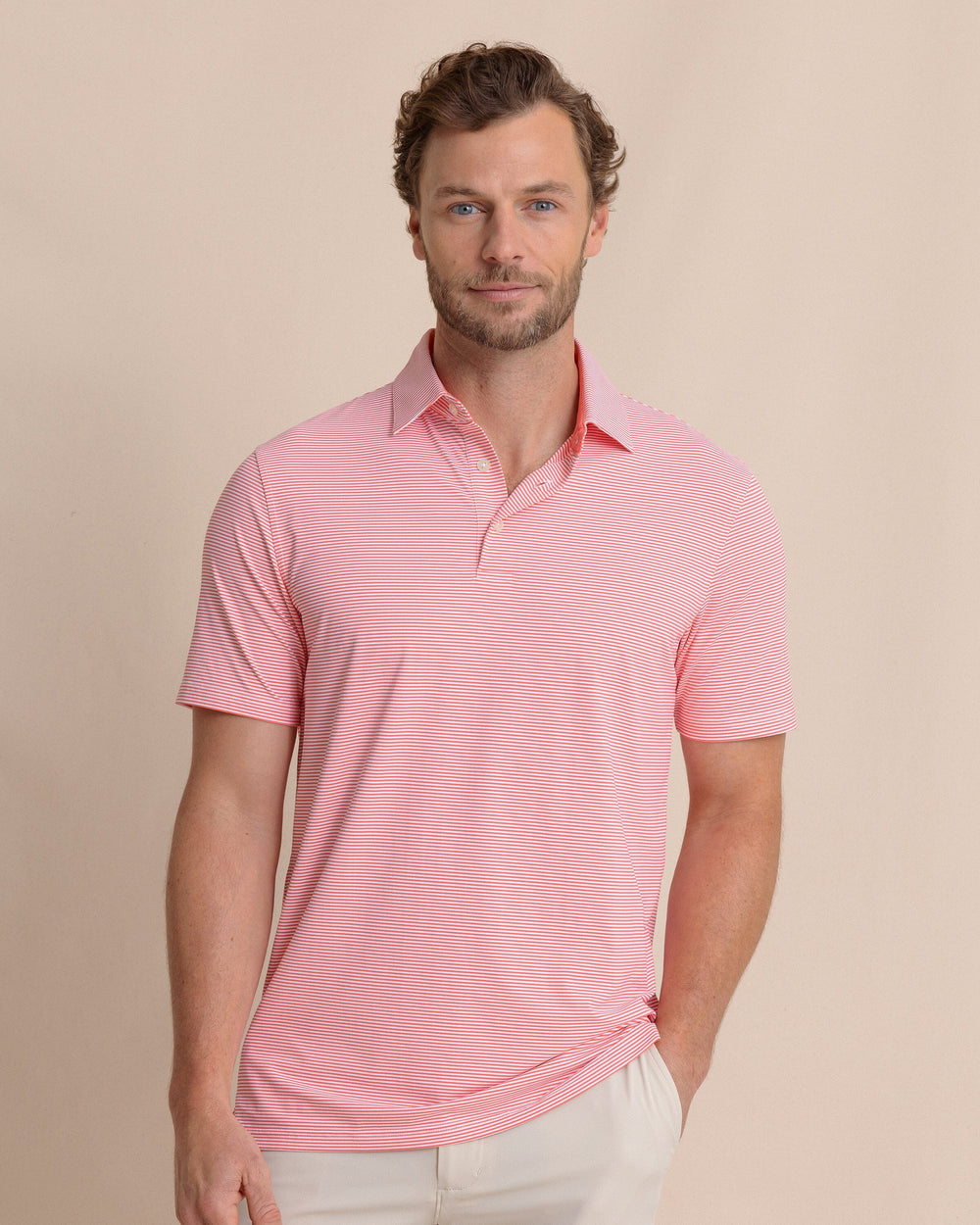 The front view of the Southern Tide brrr°®-eeze Meadowbrook Stripe Polo by Southern Tide - Sunkist Coral