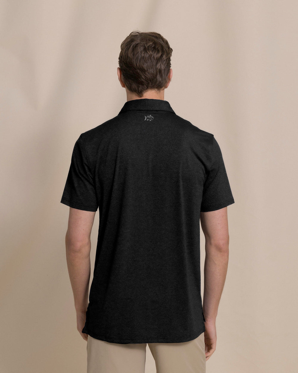 The back view of the Southern Tide Coastal Breeze® Heather Performance Polo by Southern Tide - Heather Caviar Black