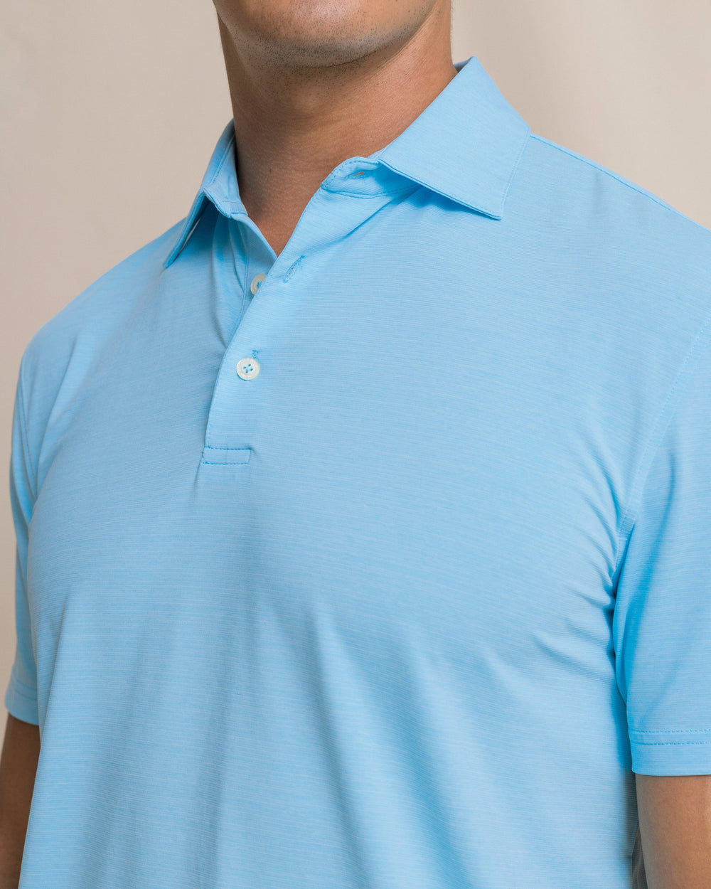 The detail view of the Southern Tide Coastal Breeze® Heather Performance Polo by Southern Tide - Heather Ocean Channel