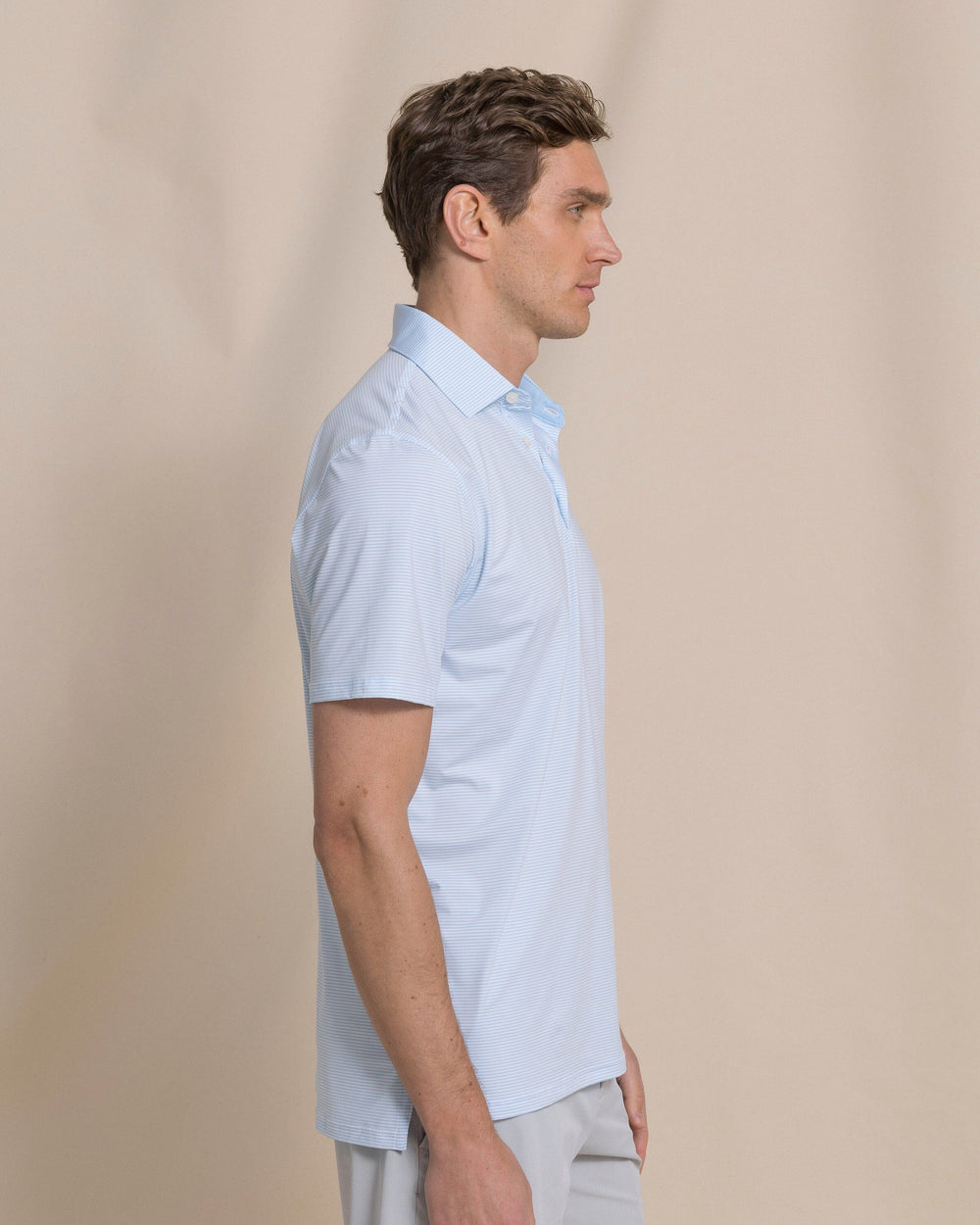 The side view of the Southern Tide Coastal Breeze® Meadowbrook Stripe Performance Polo by Southern Tide - Clearwater Blue