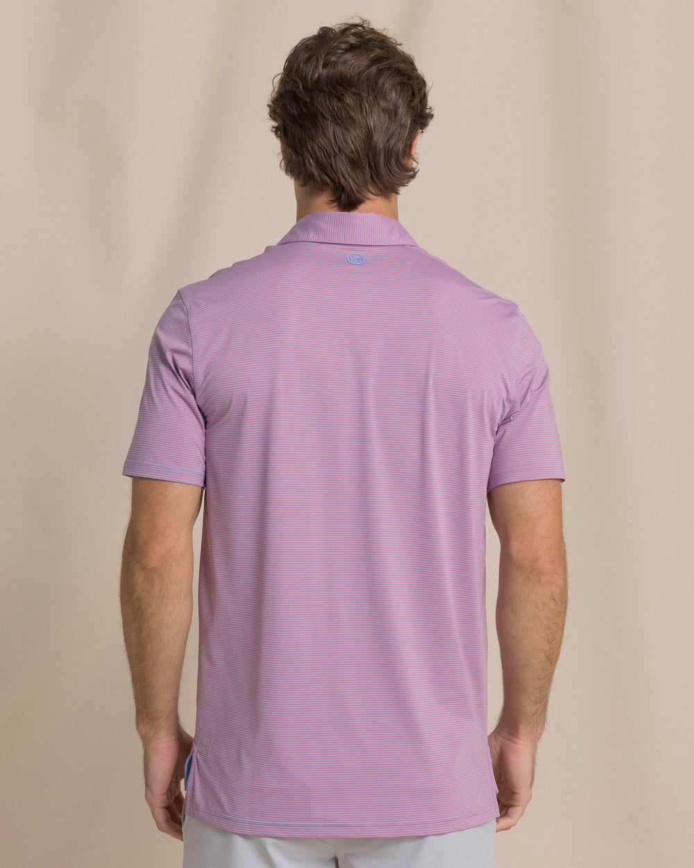 The back view of the Southern Tide Coastal Breeze® Meadowbrook Stripe Performance Polo by Southern Tide - Coral Beach