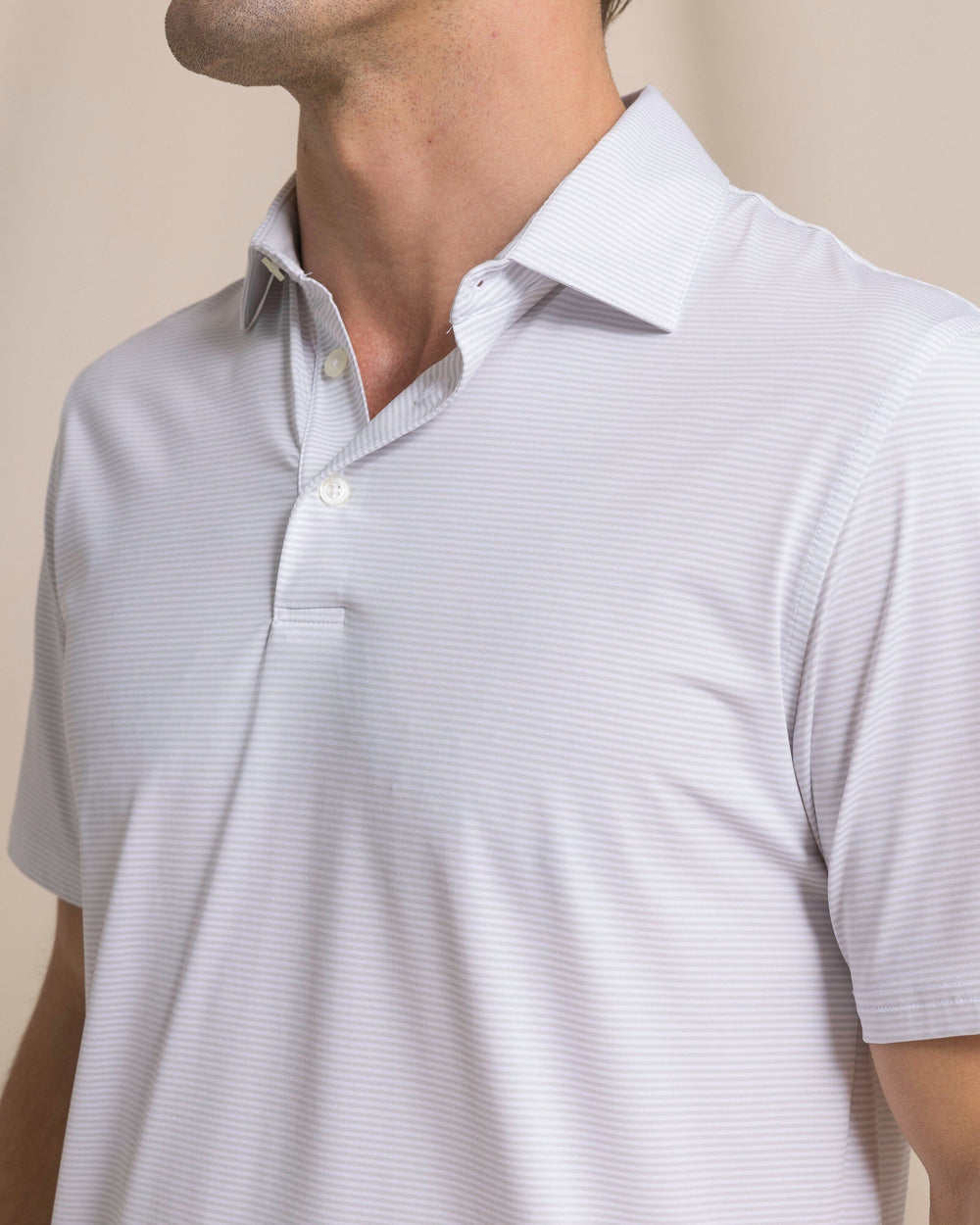 The detail view of the Southern Tide Coastal Breeze® Meadowbrook Stripe Performance Polo by Southern Tide - Platinum Grey