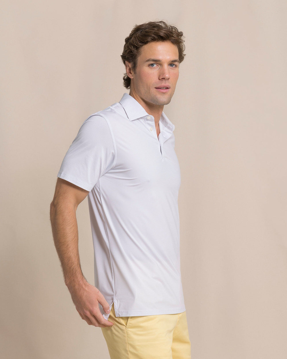 The side view of the Southern Tide Coastal Breeze® Meadowbrook Stripe Performance Polo by Southern Tide - Platinum Grey