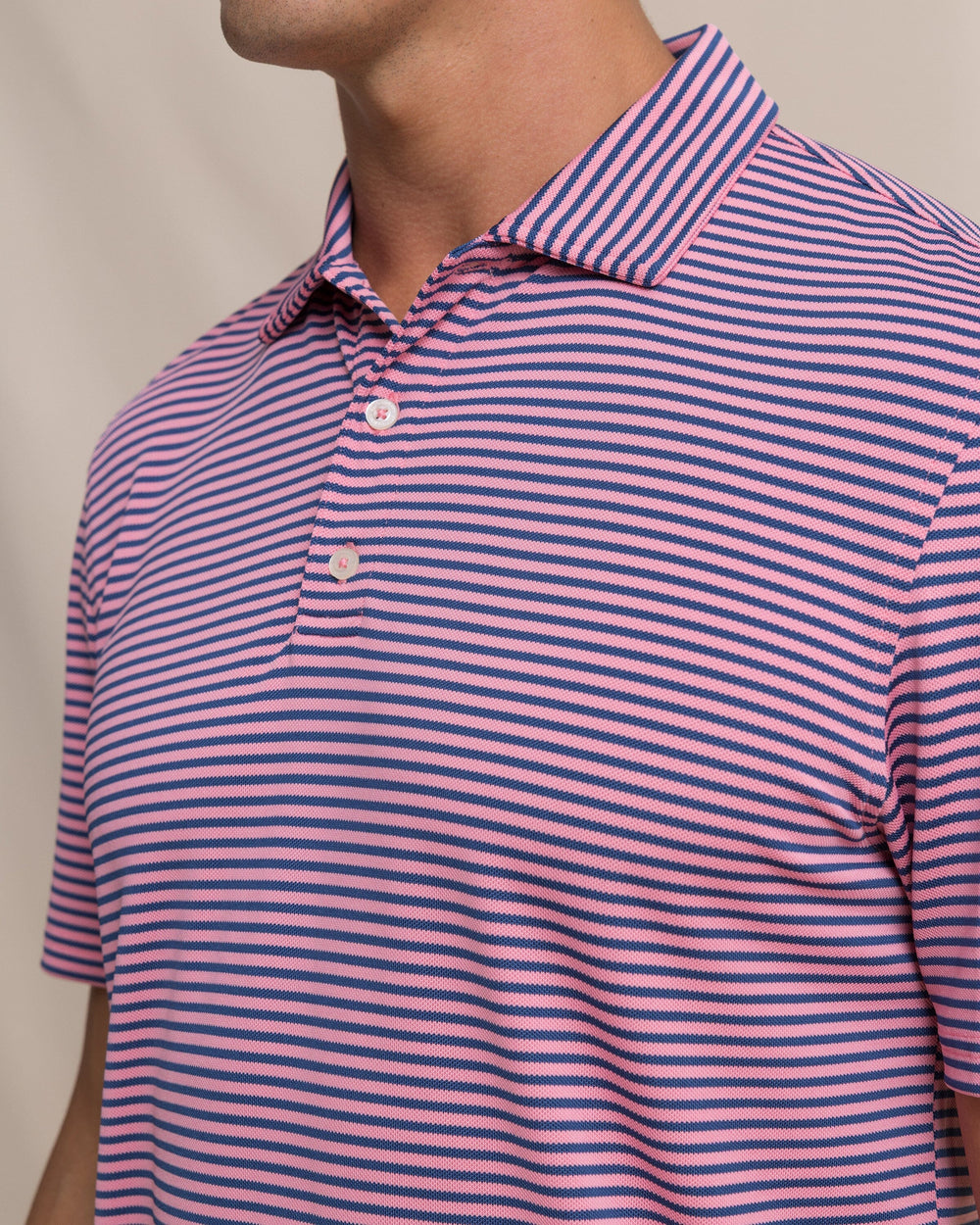 The detail view of the Southern Tide Coastal Breeze® Oceanfront Stripe Pique Performance Polo by Southern Tide - Sea Pink