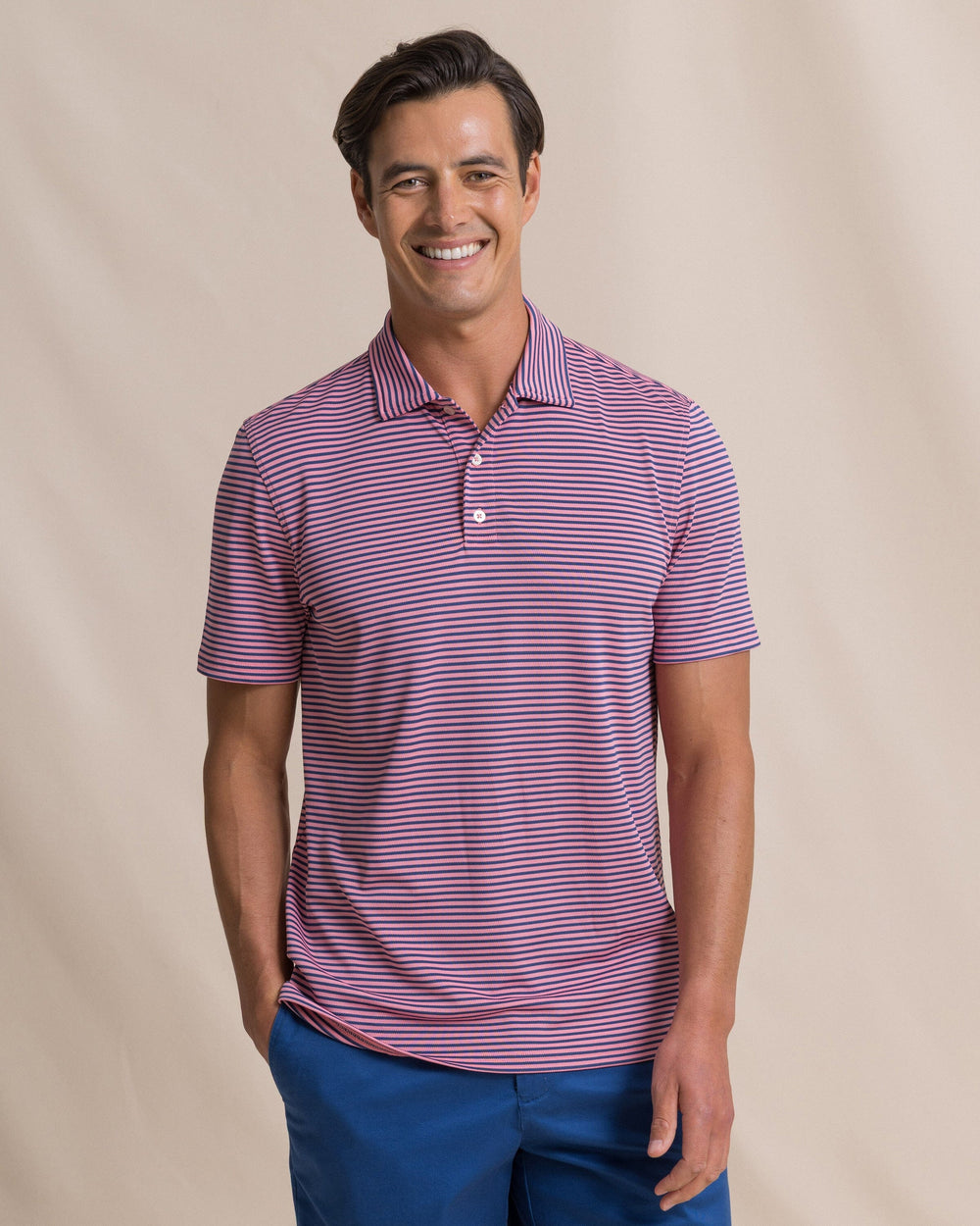 The front view of the Southern Tide Coastal Breeze® Oceanfront Stripe Pique Performance Polo by Southern Tide - Sea Pink