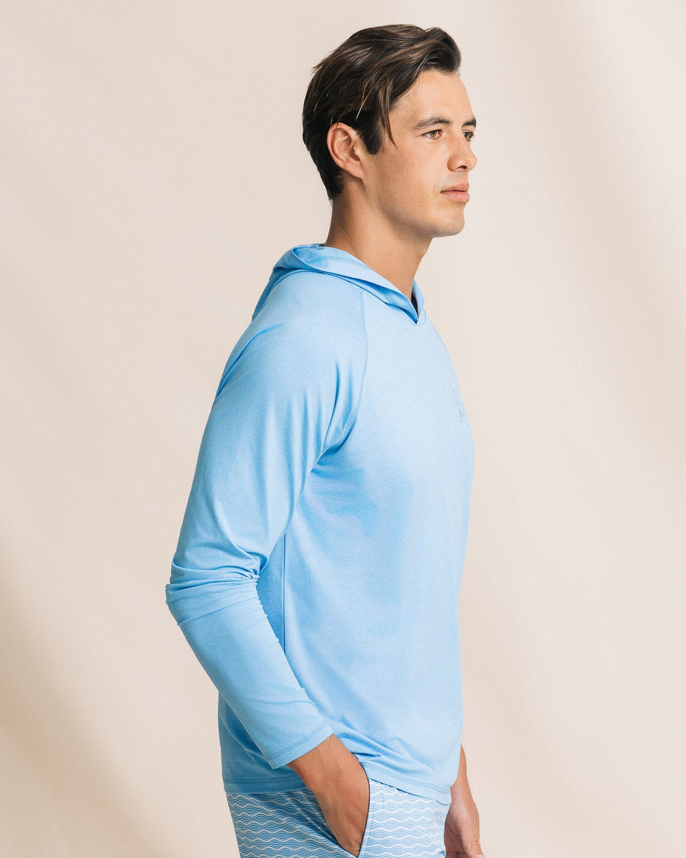 The side view of the Southern Tide Crossed Lines Coastal Breeze® Performance Hoodie by Southern Tide - Ocean Channel