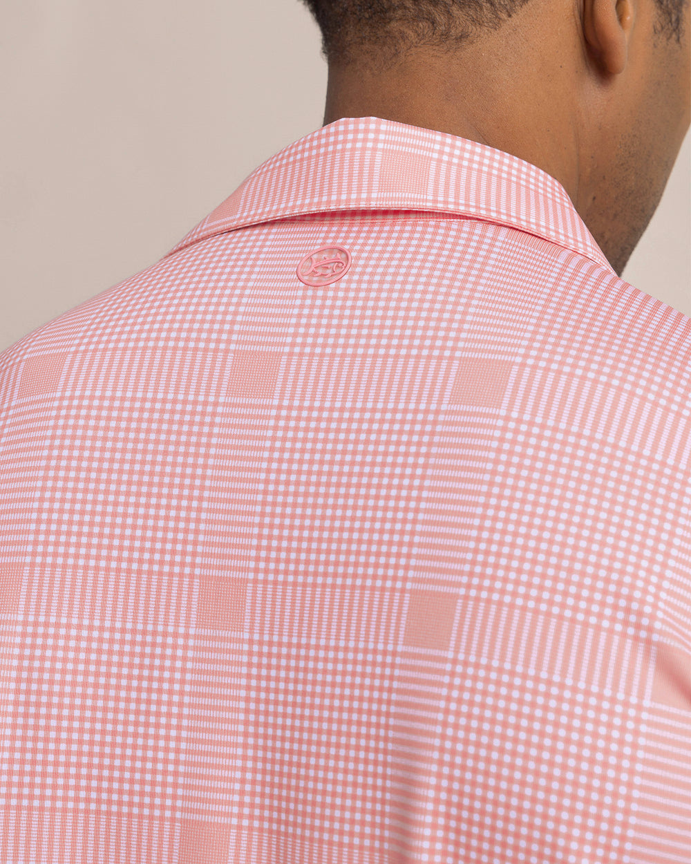 The detail view of the Southern Tide Driver Coral Key Plaid Printed Polo by Southern Tide - Sea Pink