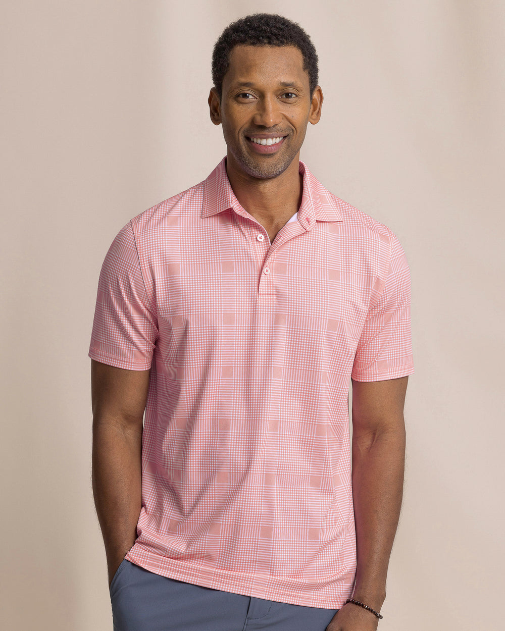 The front view of the Southern Tide Driver Coral Key Plaid Printed Polo by Southern Tide - Sea Pink