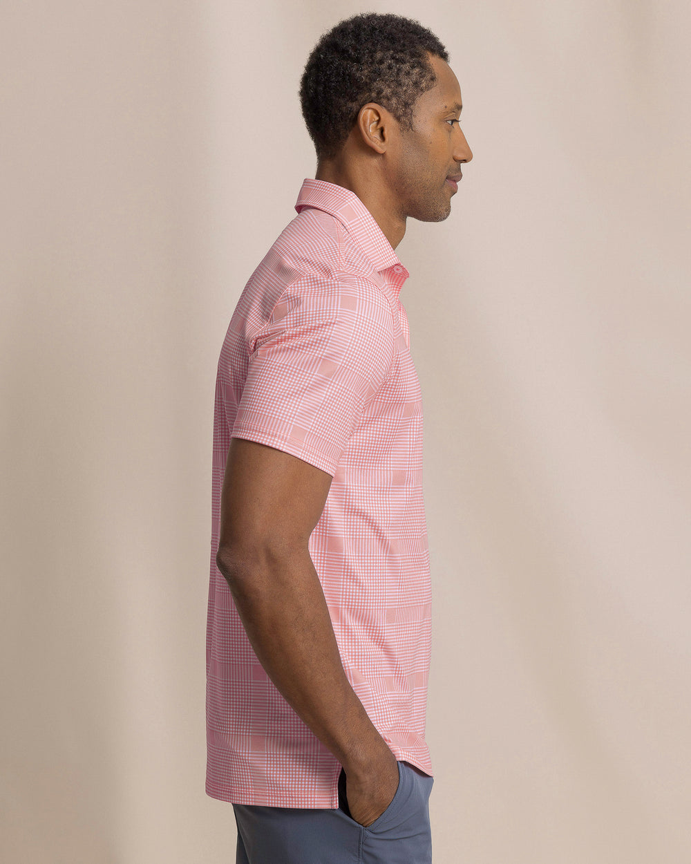 The side view of the Southern Tide Driver Coral Key Plaid Printed Polo by Southern Tide - Sea Pink