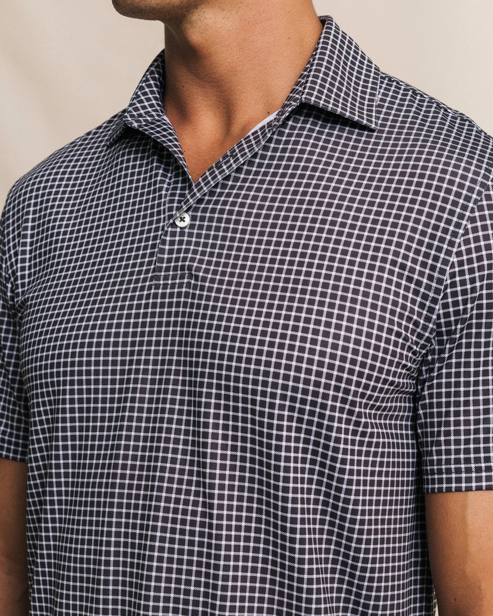 The front close view of the Southern Tide Driver Dunes Edge Team Colors Plaid Polo by Southern Tide - Black
