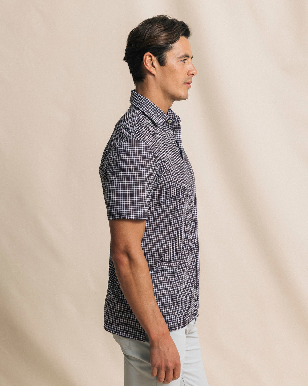 The side view of the Southern Tide Driver Dunes Edge Team Colors Plaid Polo by Southern Tide - Black