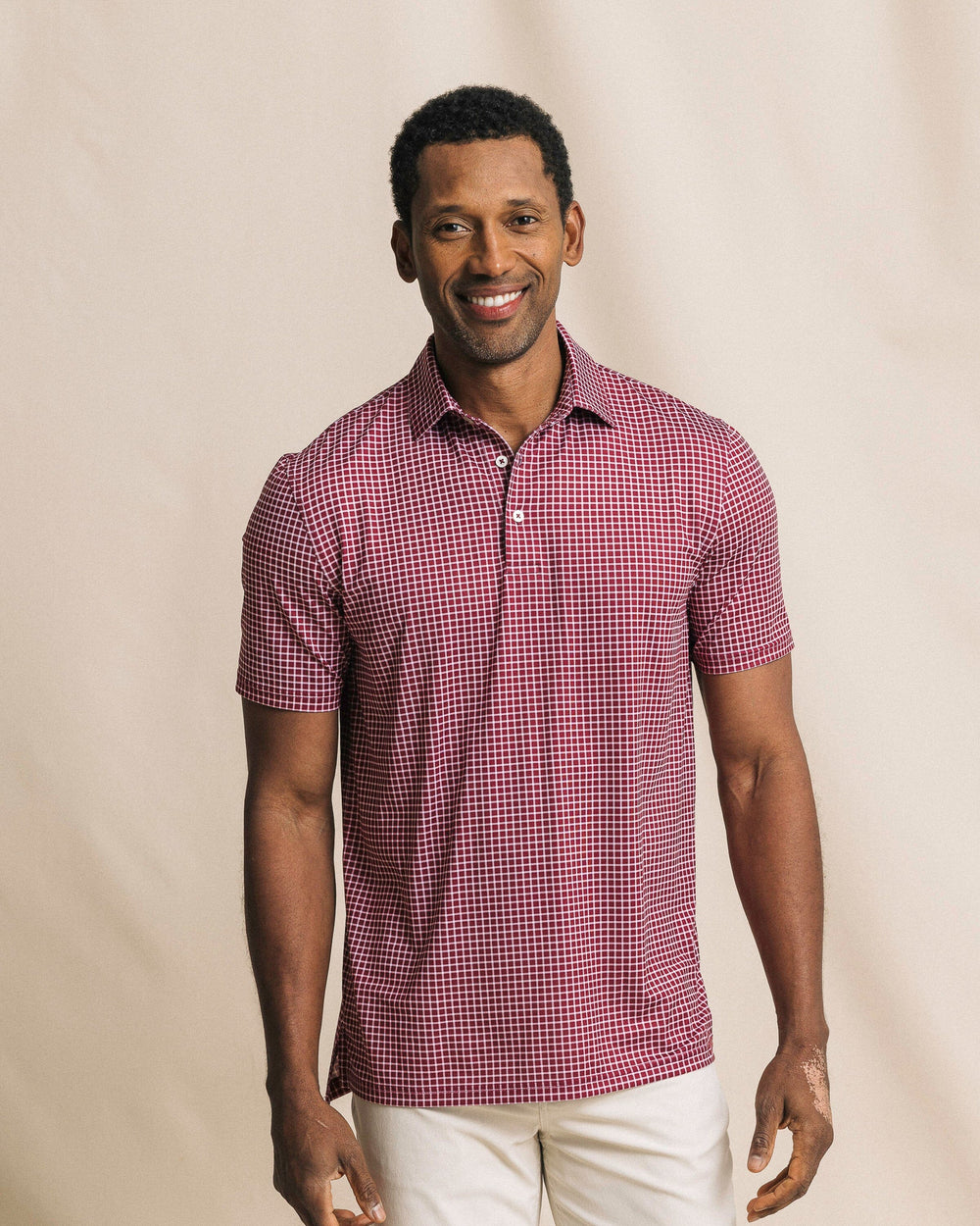 The front view of the Southern Tide Driver Dunes Edge Team Colors Plaid Polo by Southern Tide - Chianti