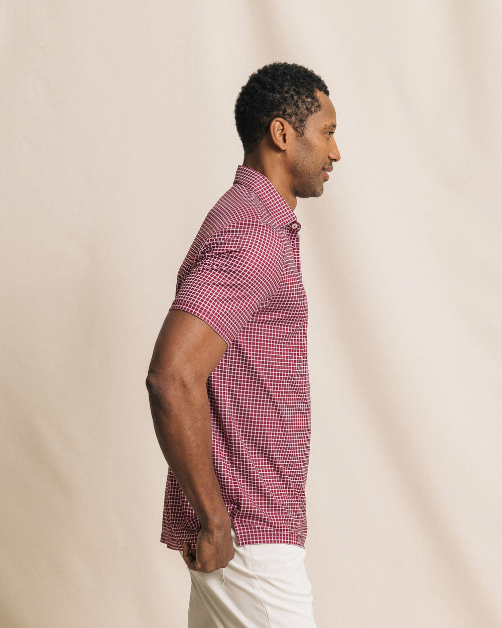 The side view of the Southern Tide Driver Dunes Edge Team Colors Plaid Polo by Southern Tide - Chianti