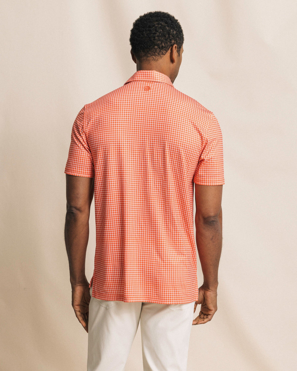 The back view of the Southern Tide Driver Dunes Edge Team Colors Plaid Polo by Southern Tide - Endzone Orange