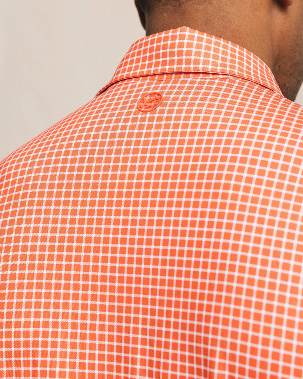 The back detail view of the Southern Tide Driver Dunes Edge Team Colors Plaid Polo by Southern Tide - Endzone Orange