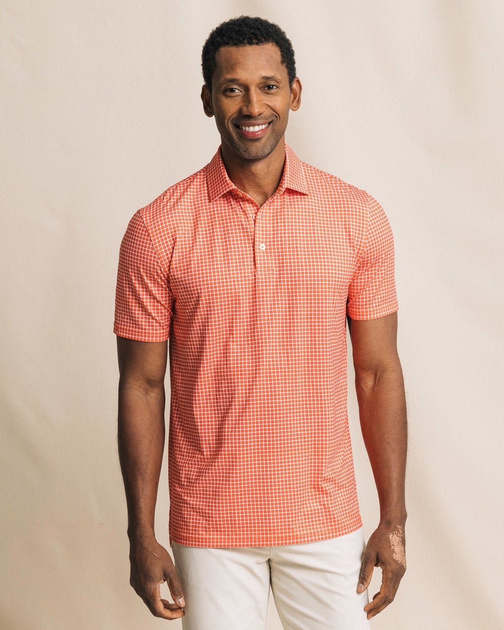 The front view of the Southern Tide Driver Dunes Edge Team Colors Plaid Polo by Southern Tide - Endzone Orange