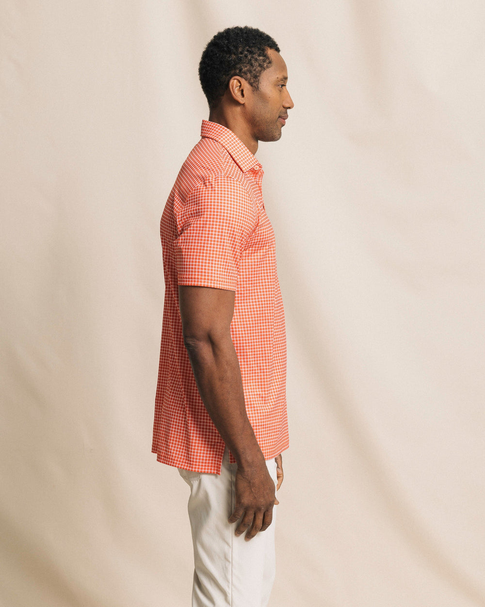 The side view of the Southern Tide Driver Dunes Edge Team Colors Plaid Polo by Southern Tide - Endzone Orange