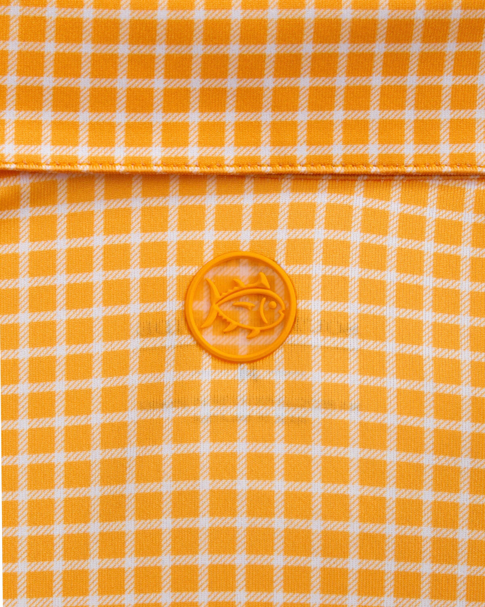 The detail view of the Southern Tide Driver Dunes Edge Team Colors Plaid Polo by Southern Tide - Rocky Top Orange