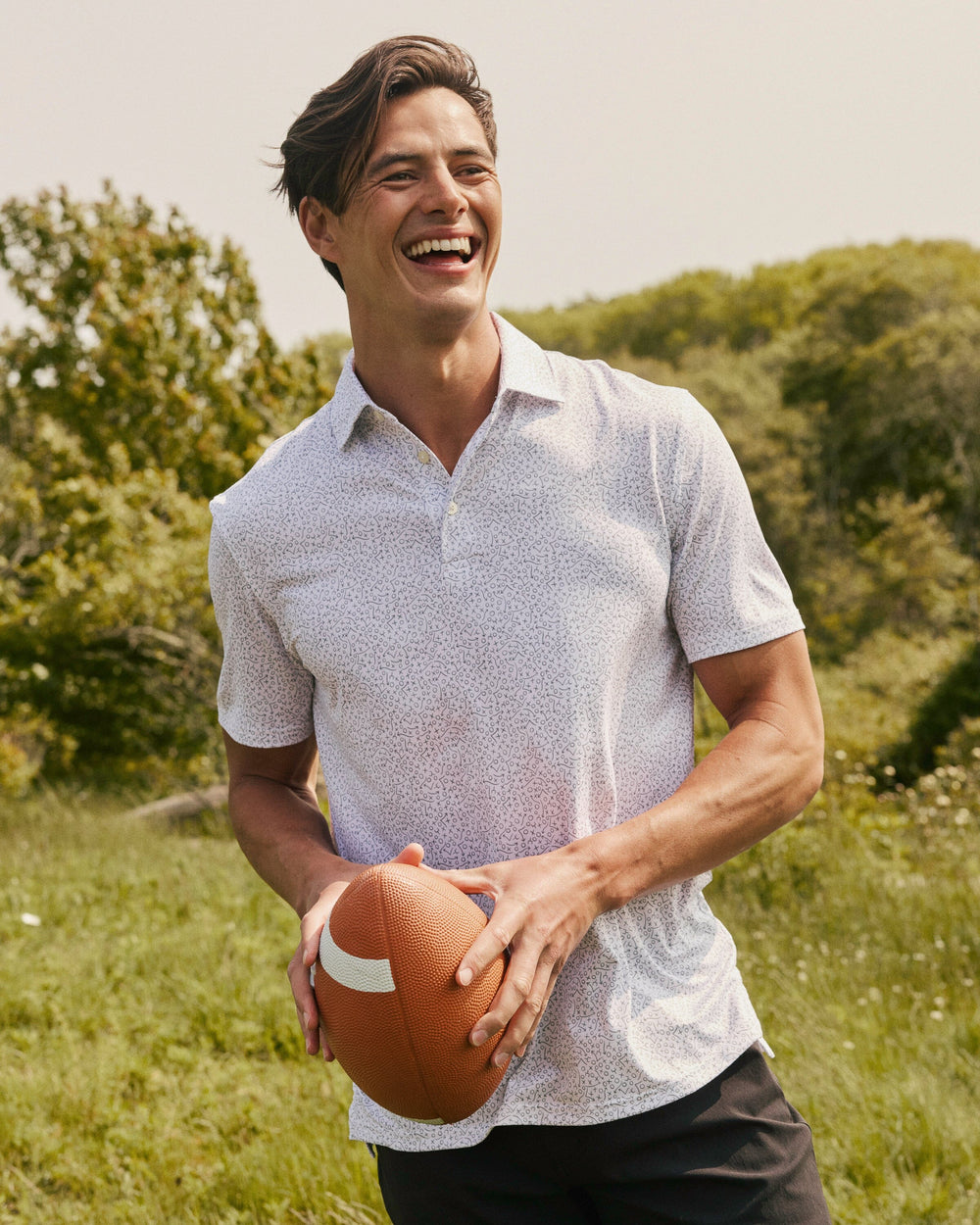 The lifestyle view of the Southern Tide Driver Gameplay Polo by Southern Tide - Classic White