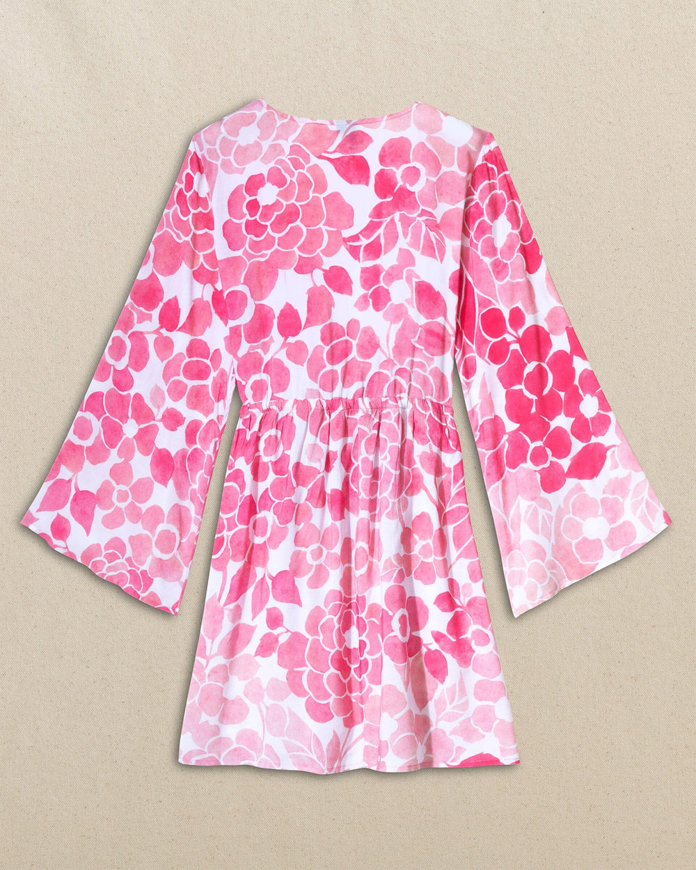 The back view of the Southern Tide Floral Bell Sleeve Short Tunic Cover-Up by Southern Tide - Island Pink