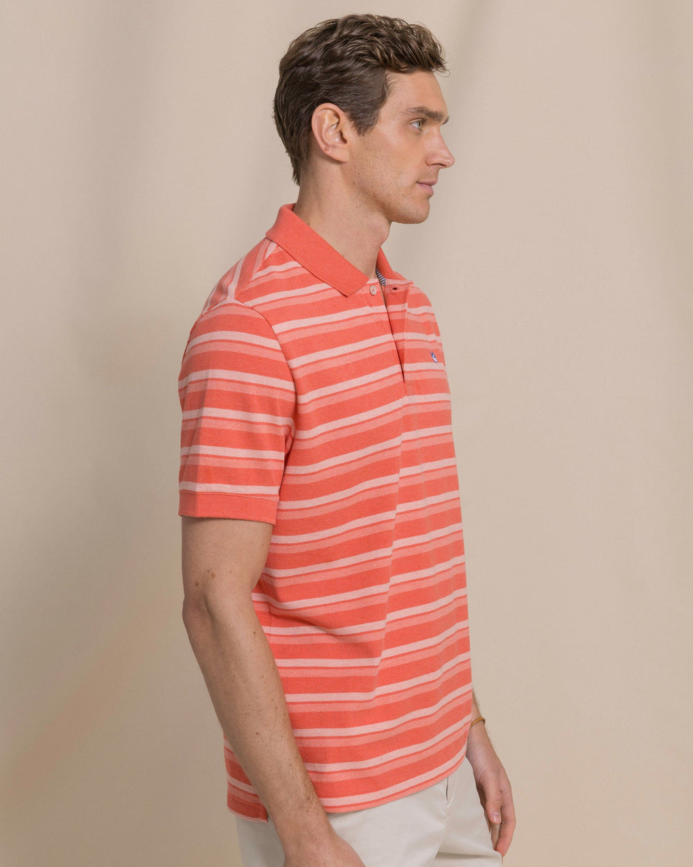 The side view of the Southern Tide Heather Striped Skipjack Polo by Southern Tide - Heather Coral Beach