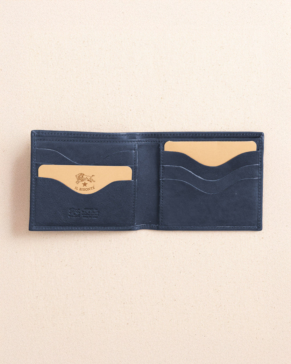 The open view of the Il Bisonte Classic Bifold Wallet at Southern Tide - Blue Mezzanotte