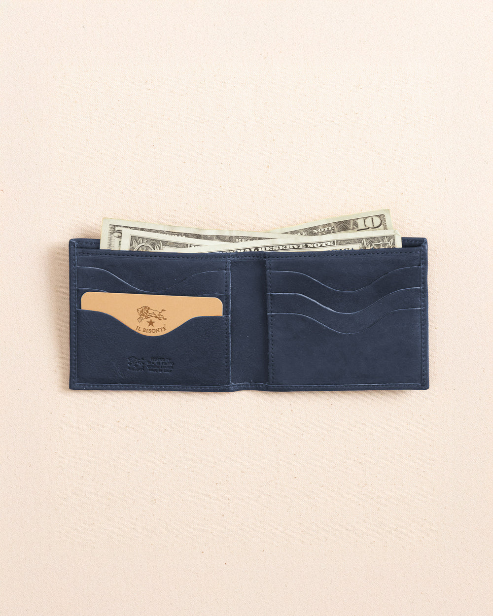 The open view of the Il Bisonte Classic Bifold Wallet at Southern Tide - Blue Mezzanotte