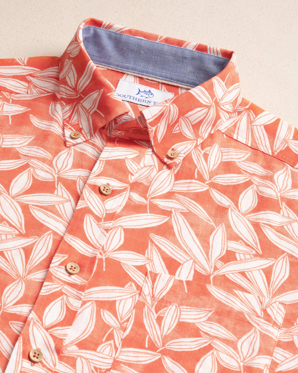 The detail view of the Southern Tide Kokomo Row Linen Rayon Short Sleeve Sport Shirt by Southern Tide - Orange Blossom