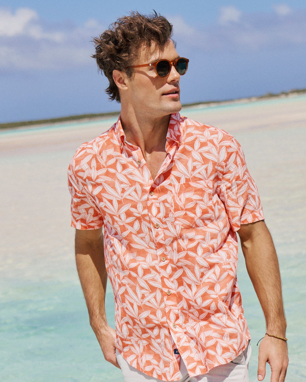 The lifestyle view of the Southern Tide Kokomo Row Linen Rayon Short Sleeve Sport Shirt by Southern Tide - Orange Blossom