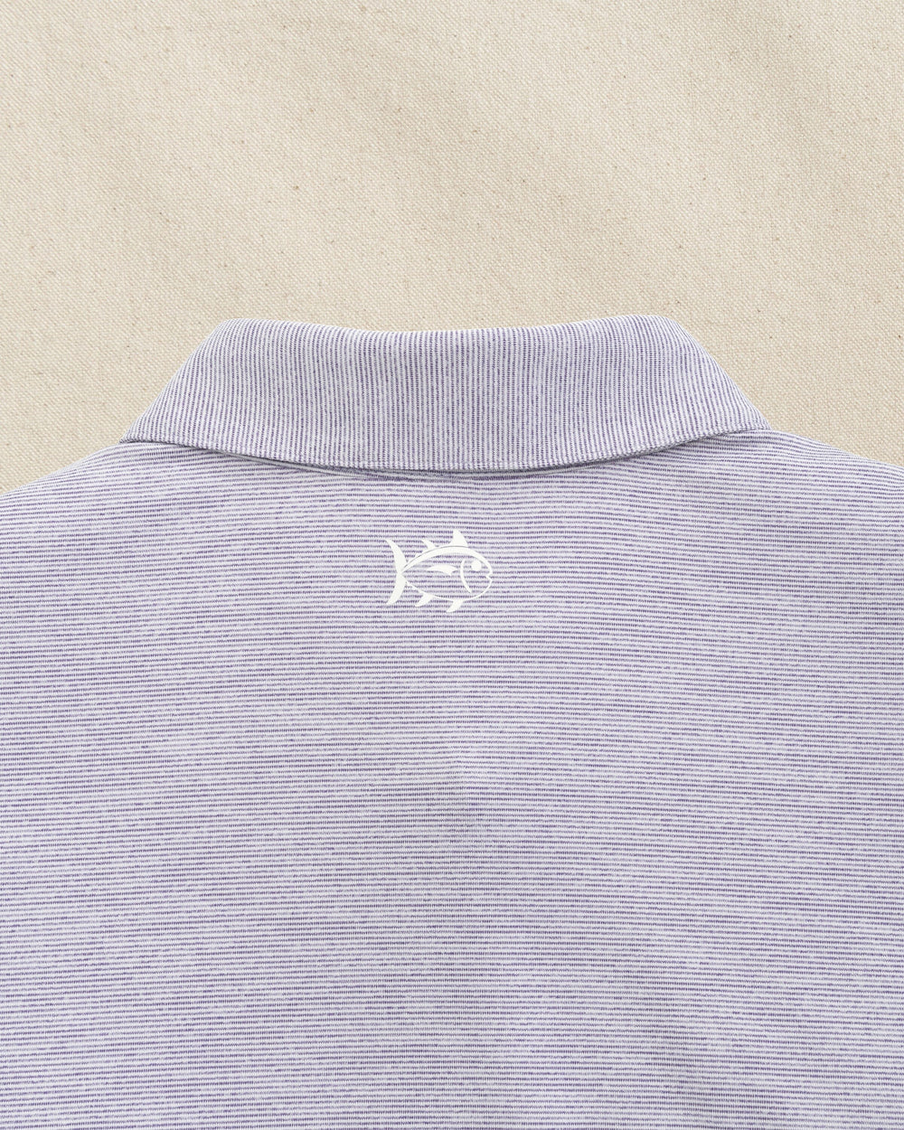 The detail view of the Southern Tide LSU 2025 Baseball National Champions Driver Spacedye Polo by Southern Tide - Regal Purple