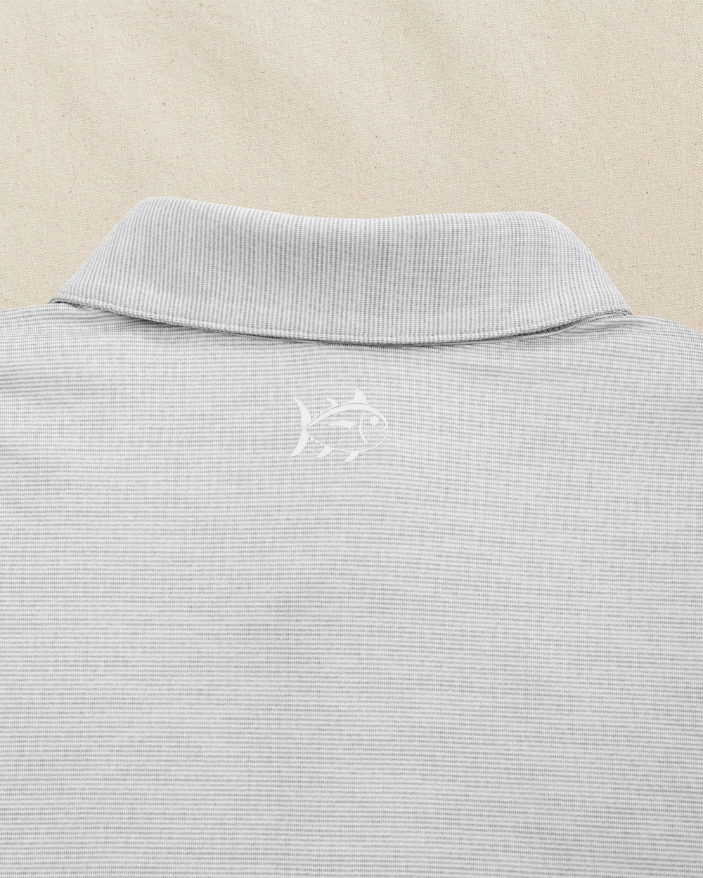 The detail view of the Southern Tide LSU 2025 Baseball National Champions Driver Spacedye Polo by Southern Tide - Slate Grey