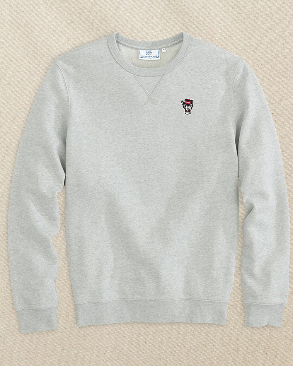 The front view of the Southern Tide NC State Wolf Head Upper Deck Pullover Sweatshirt by Southern Tide - Heather Slate Grey
