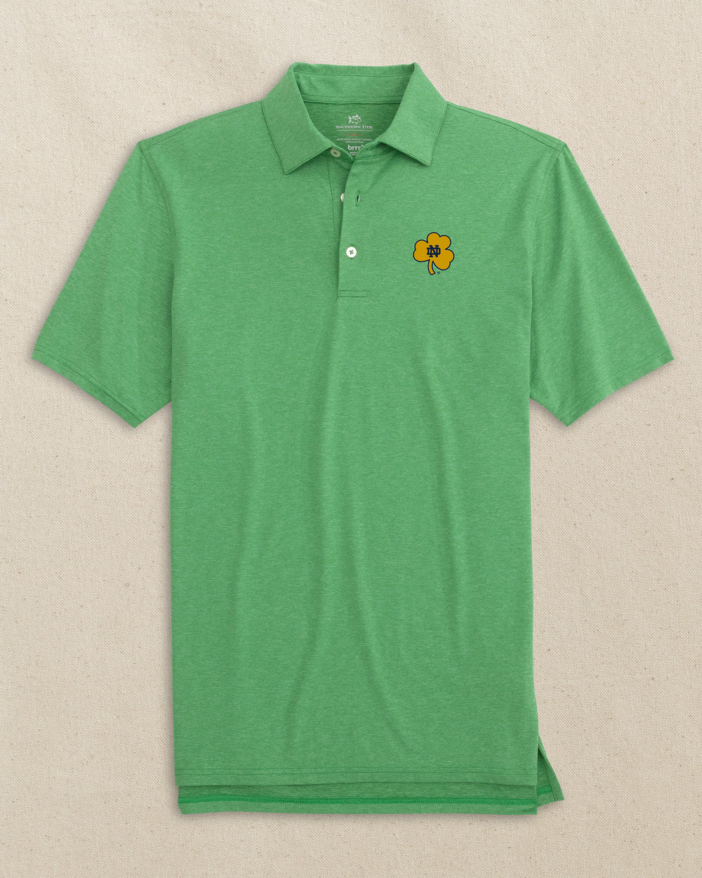 The front view of the Southern Tide Notre Dame Fighting Irish brrr°®-eeze Heather Performance Polo by Southern Tide - Heather Kelly Green